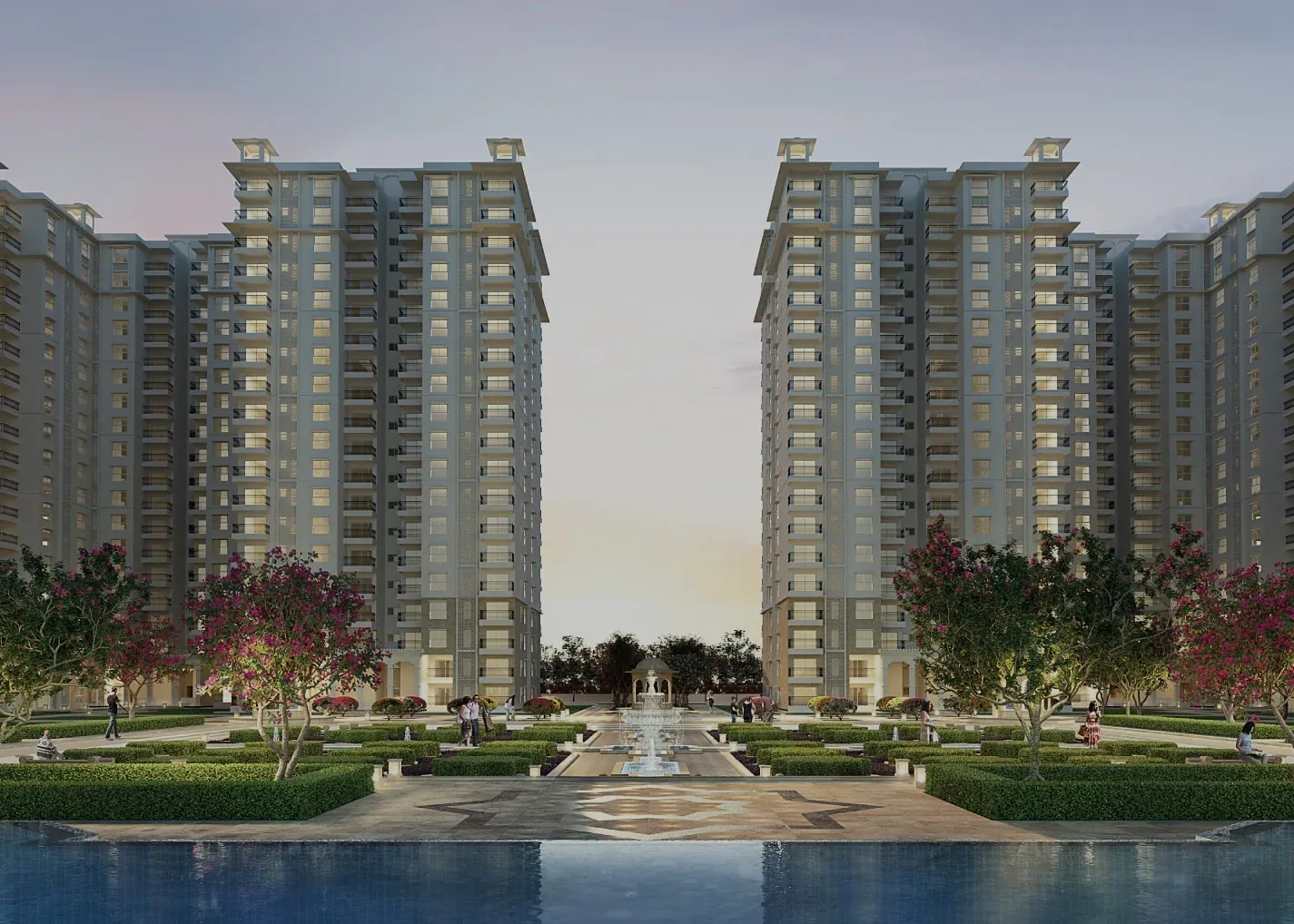 Towers either side of a long water garden with a fountain at dusk, at SOBHA Royal Pavilion