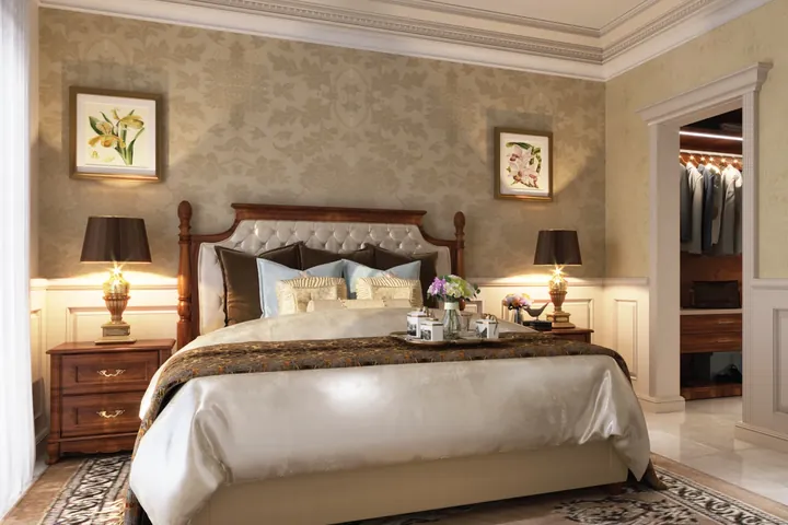 A bedroom with a tufted headboard, bedside lamps and a dressing table